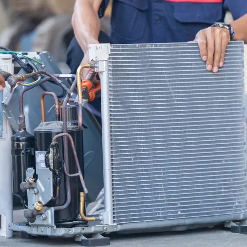 a person working on an hvac unit