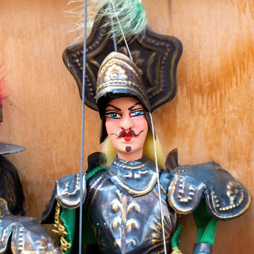 Two traditional marionette puppets dressed as armored knights with detailed costumes and expressive faces.