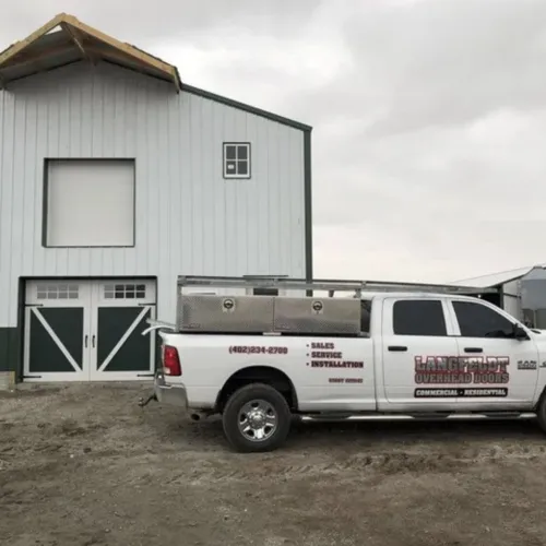 a white truck parked in front of a white building
