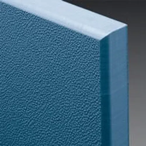 Close-up of blue foam insulation board with textured surface and beveled edges against gray background