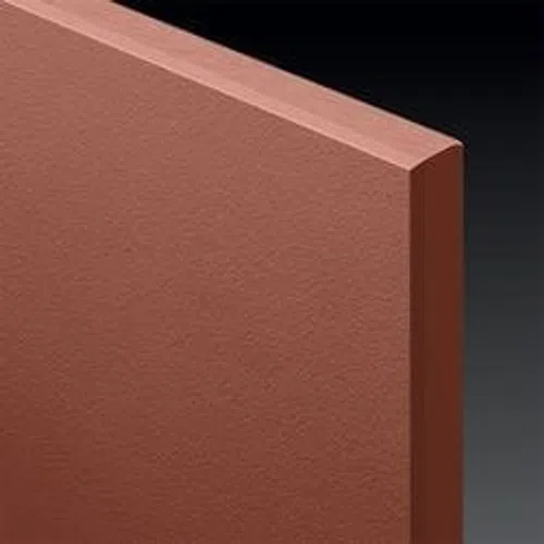 Close-up of a textured brown foam insulation board with sharp edges on a dark gradient background