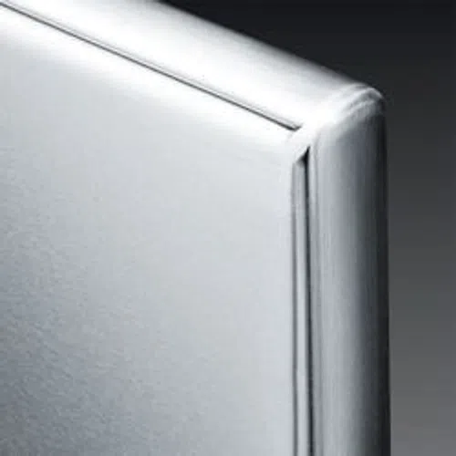 Close-up of a white leather upholstered bed headboard with smooth stitching and padding.