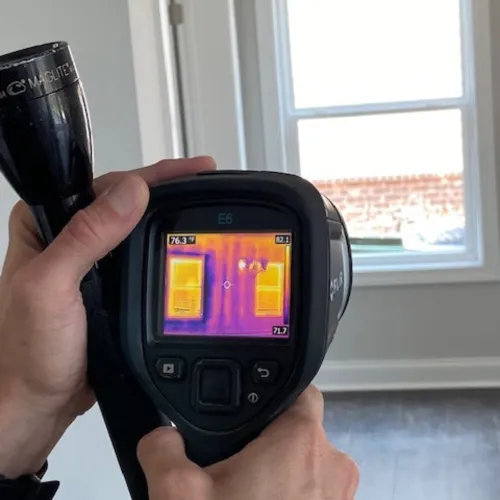 a person holding an infrared camera