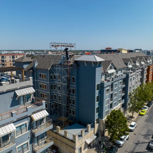 a group of buildings with cars parked in front of them