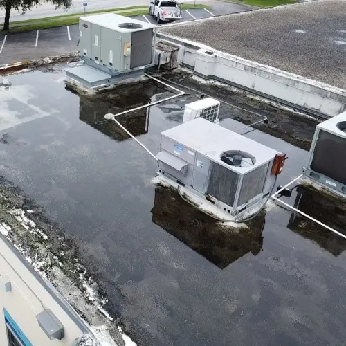 a flooded street with cars and a truck