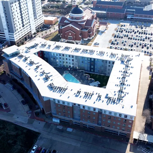 Aerial view of TPO flat roof installation on The Stack Apartments student housing complex in College Station Texas