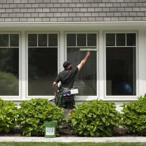 a man standing outside a house