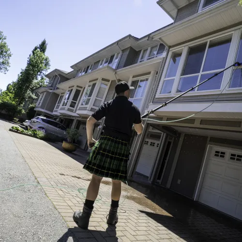 a person in a kilt walking on a street