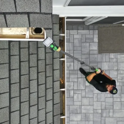 a person holding a gutter camera
