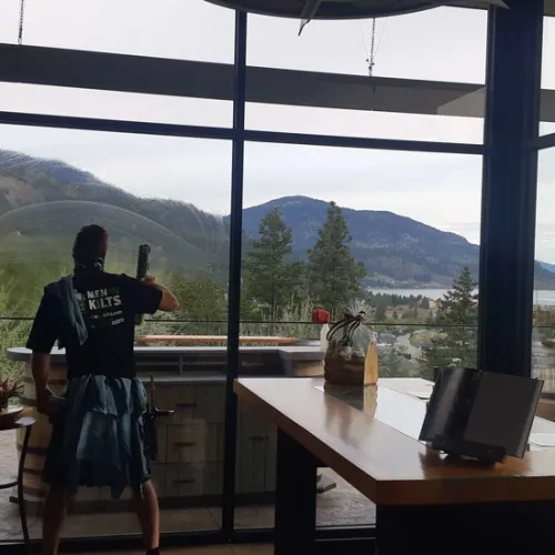 a person standing in front of a table with a laptop on it