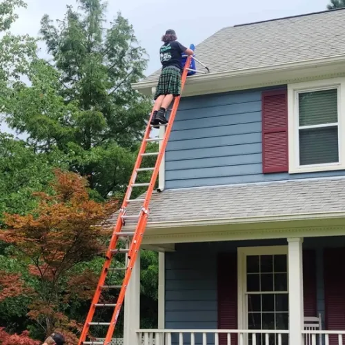 a person on a ladder on a house