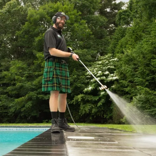 a person holding a pressure washer wand