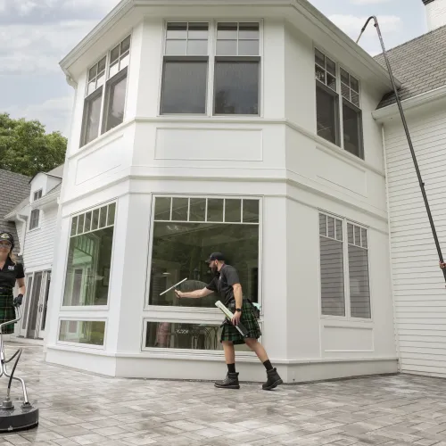 a group of people washing a house