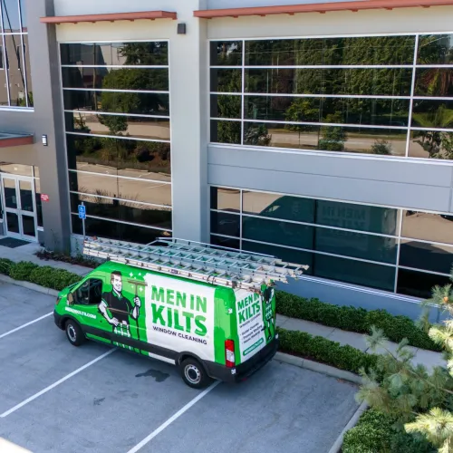 a green truck parked in front of a building