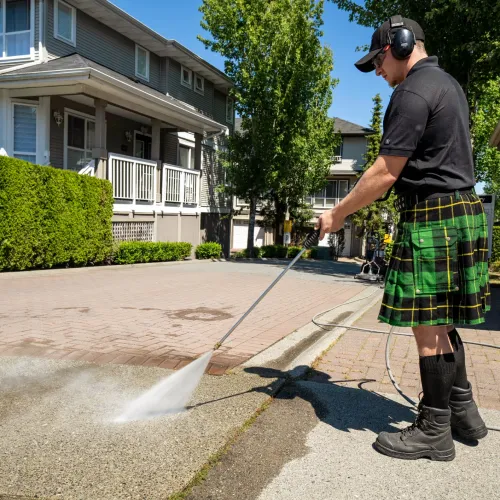 a man wearing a kilt and holding a stick