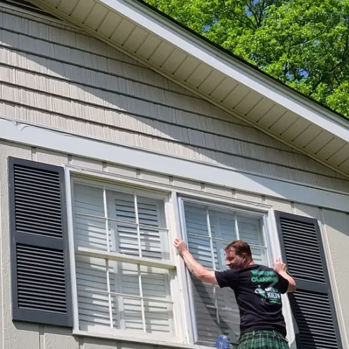 a man standing outside a house