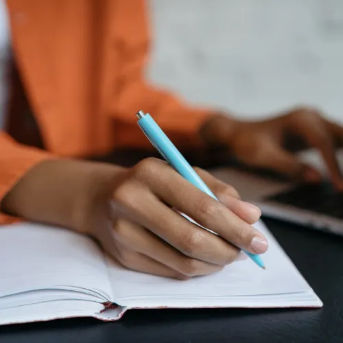 woman writing with a pen