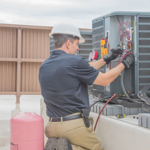 a man installing a heating, ventilation, and air conditioning system in Dallas, GA