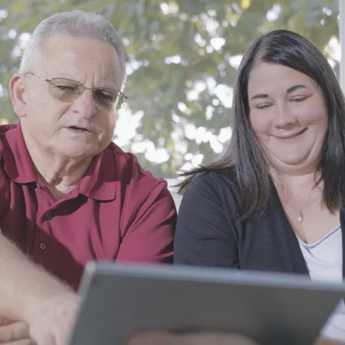a few people looking at a laptop during a window consultation