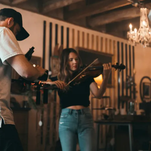 a man and woman playing instruments