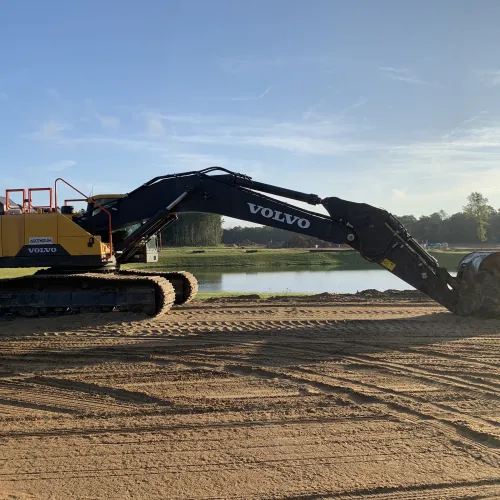 an excavator working on a field