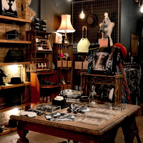 a room with a table and shelves with objects on it