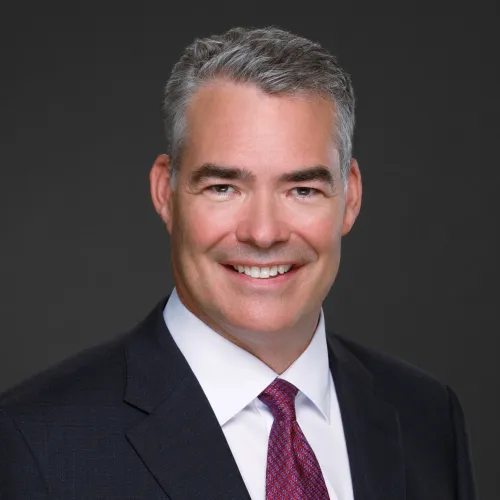 a man in a suit smiling