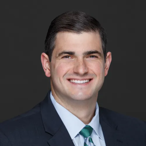 a man in a suit smiling