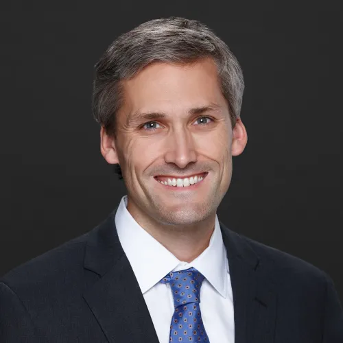 a man in a suit smiling