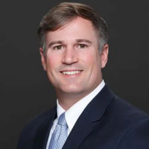 a man in a suit smiling