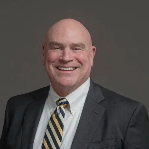 a man in a suit smiling