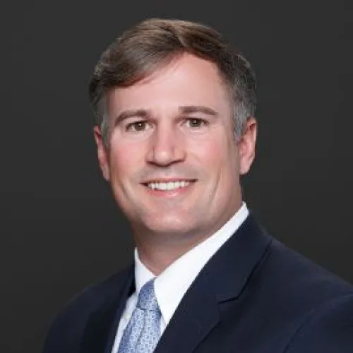 a man in a suit smiling