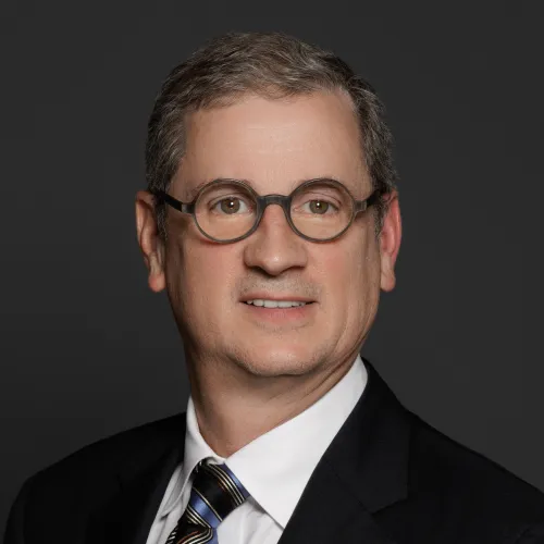 a man wearing glasses and a suit