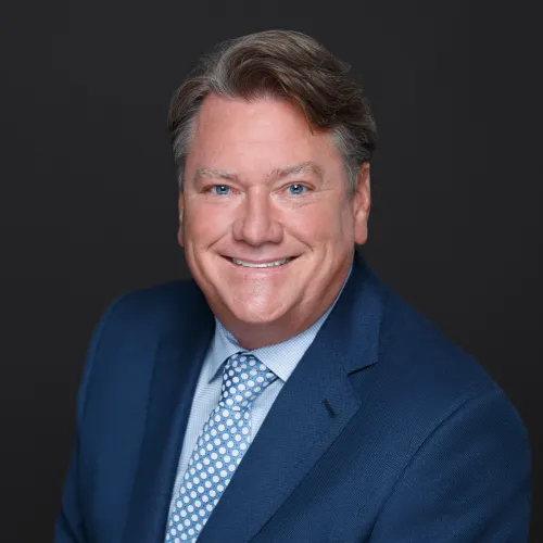a man in a suit smiling