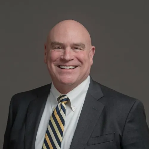 a man in a suit smiling