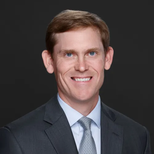 a man in a suit smiling