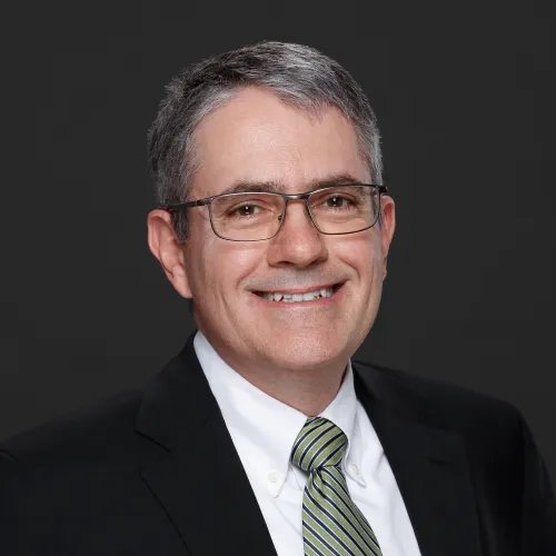 a man wearing glasses and a suit