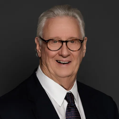 a man wearing glasses and a suit