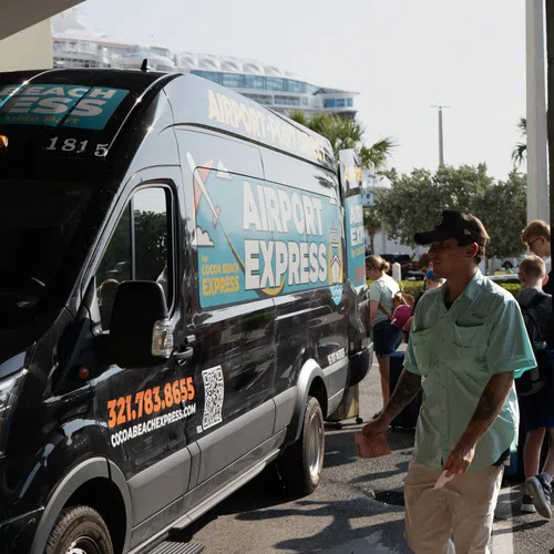 Cruise passengers boarding a shuttle on a sunny day