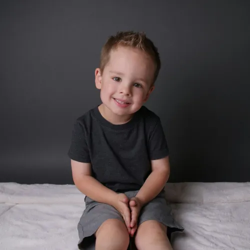 a boy sitting on a bed