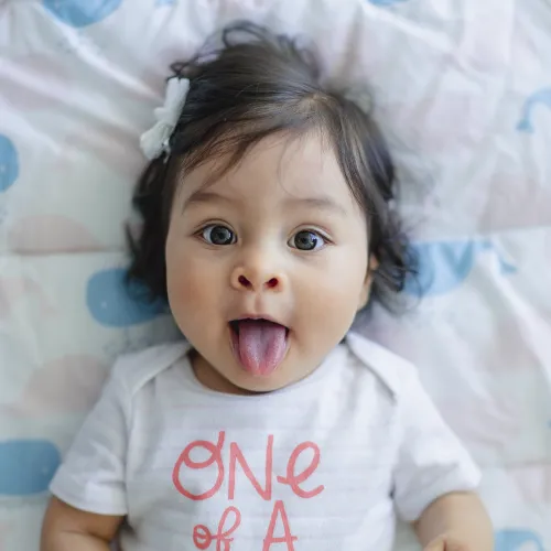 a baby with a pink shirt