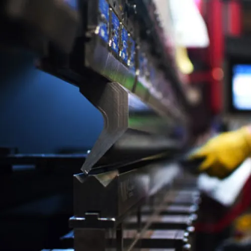 Close-up of a precision machining tool in action, highlighting industrial metalwork and craftsmanship.