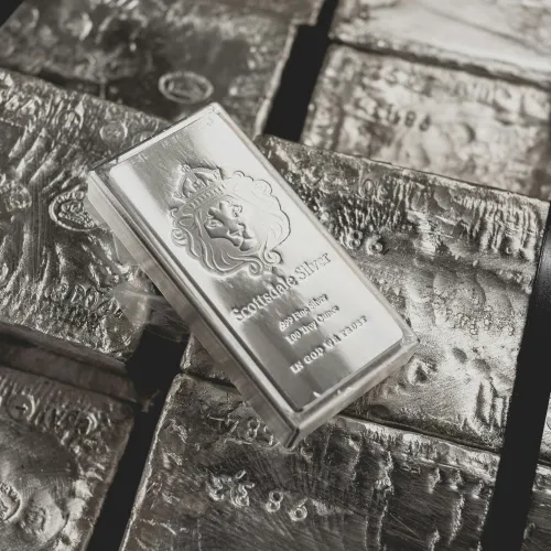 Stacked silver bars with one prominent bar embossed with a lion crest and silver purity details.