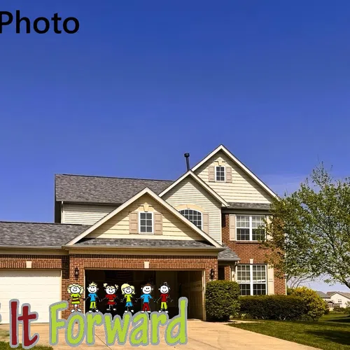 Clean suburban two-story house with brick and siding exterior under clear blue sky and landscaped yard.