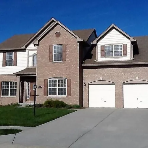 a large brick house with a wide driveway