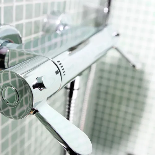a shower head with a glass door