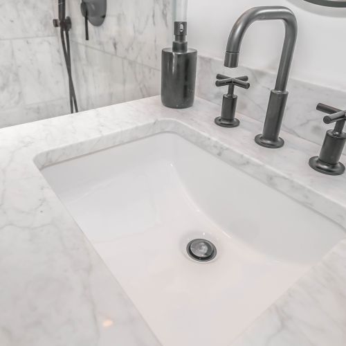 a bathtub with a faucet and a soap dispenser