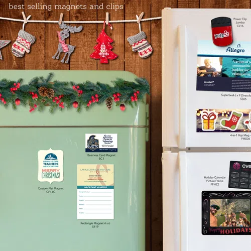 Refrigerators decorated with various holiday-themed magnets, clips, business cards, and calendars in a cozy setting.