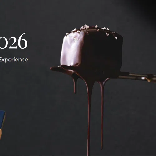 Gift Guide 2026 text with wrapped presents and dripping dark chocolate on spoon against black background