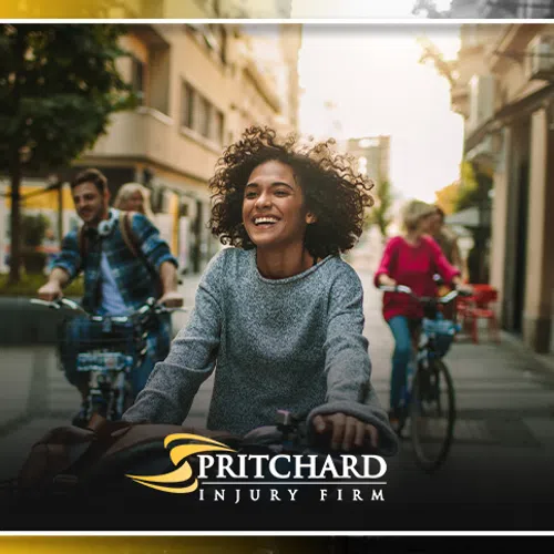 Happy young woman riding bicycle in city with friends on bikes during golden hour light.